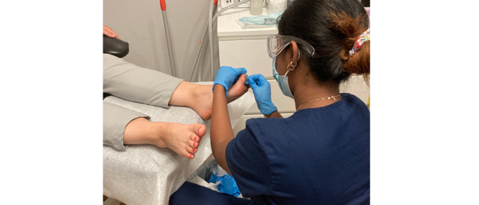 chiropodist fixing patients toe with diabetic condition